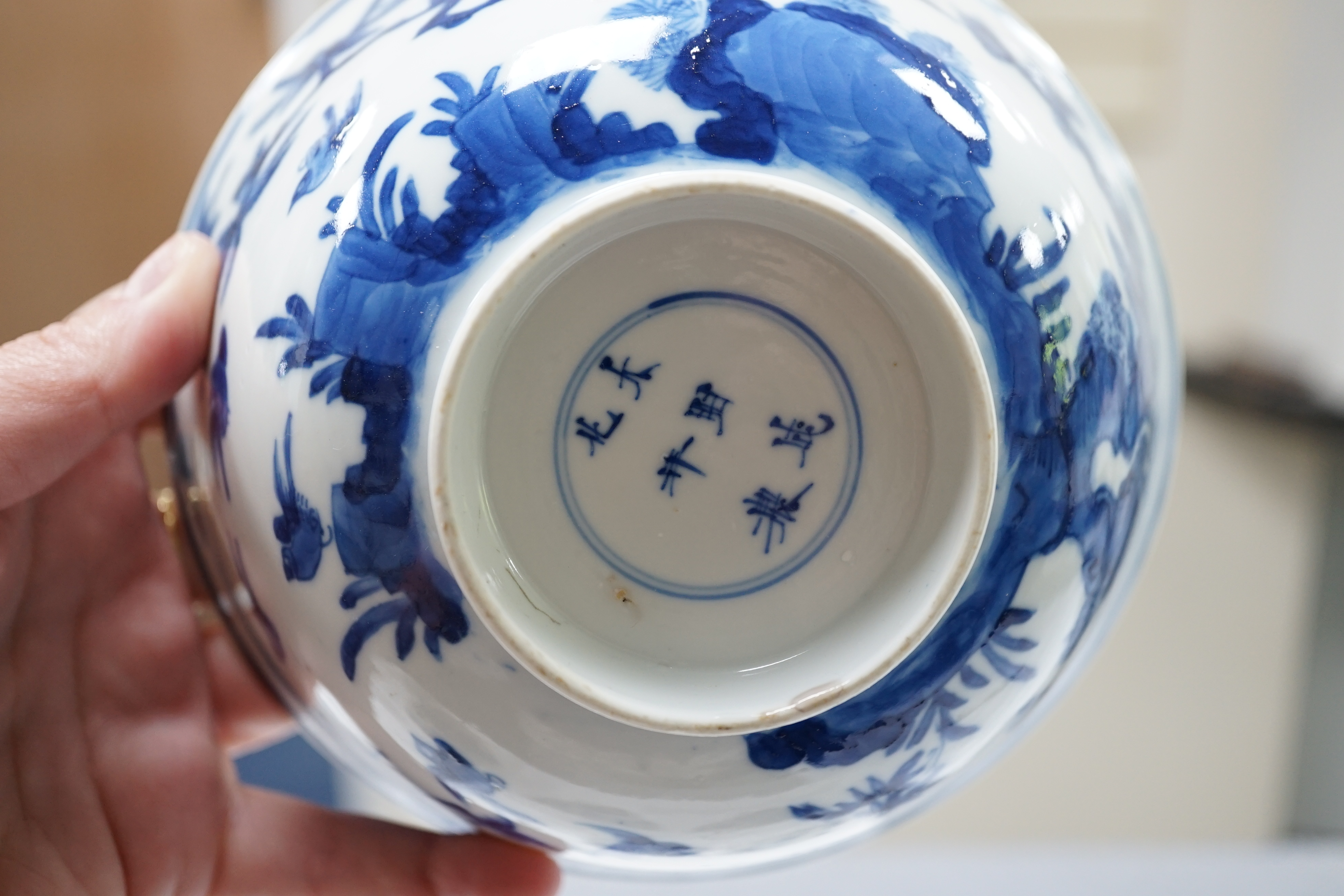 A near pair of Chinese blue and white ‘birds’ bowls, Kangxi period, one bowl restored